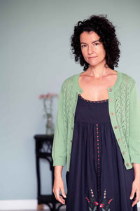 Juliet in charcoal dress with mineral green cardigan