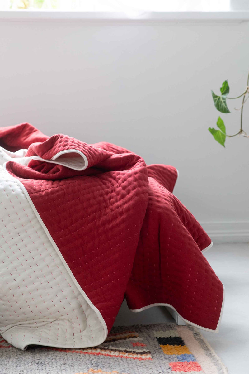 Kantha Garnet quilt on bed
