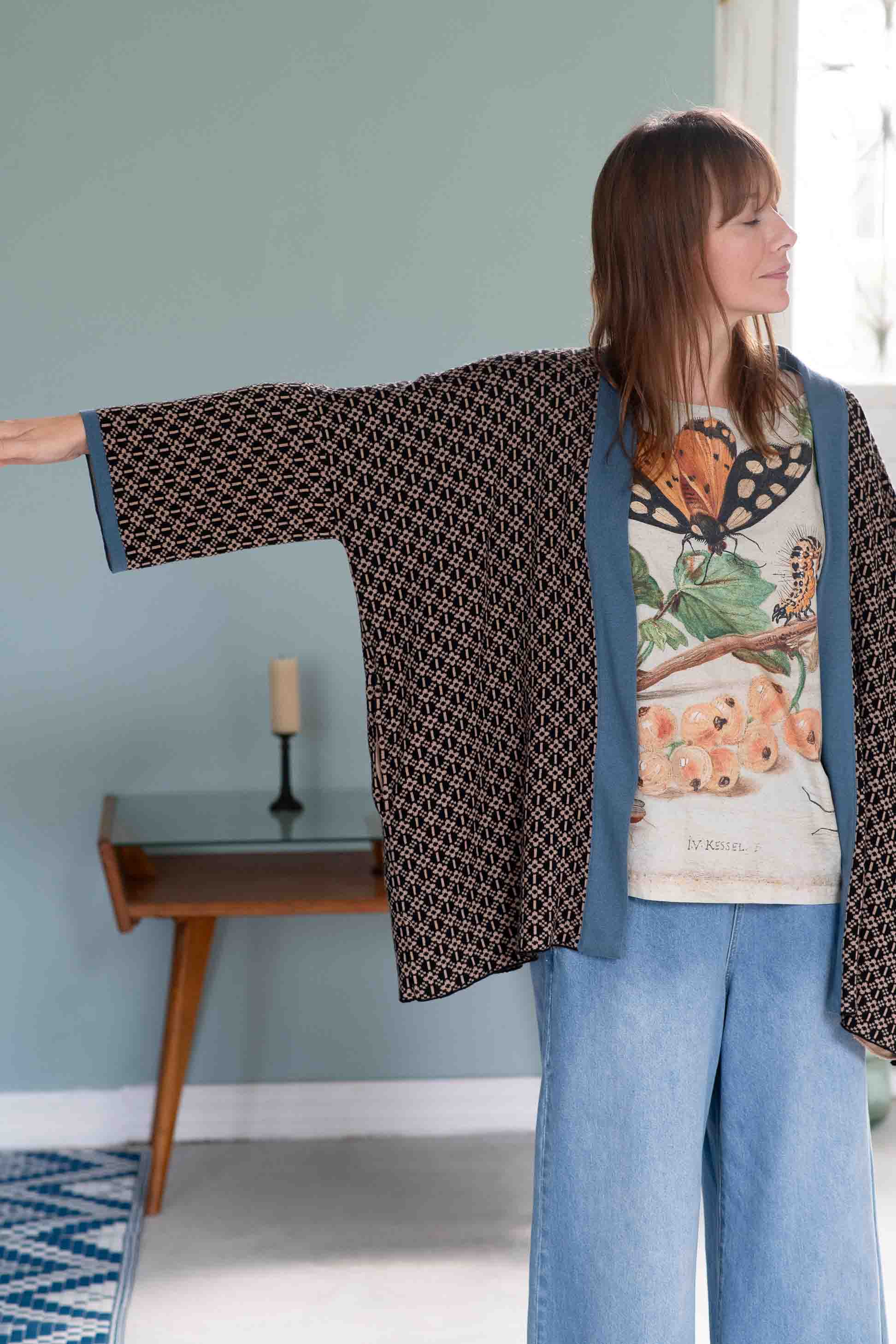 Woman in Lola cardigan with insect print shirt and denim