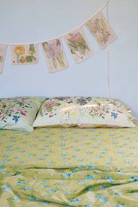 Matilda Smith Garland floral bedsheets and garland in a busy garden.
