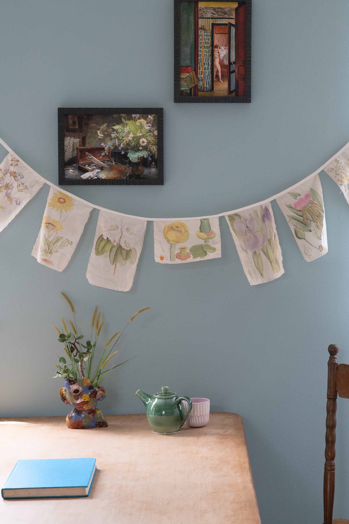 Matilda Smith Garland floral banner and art on blue wall