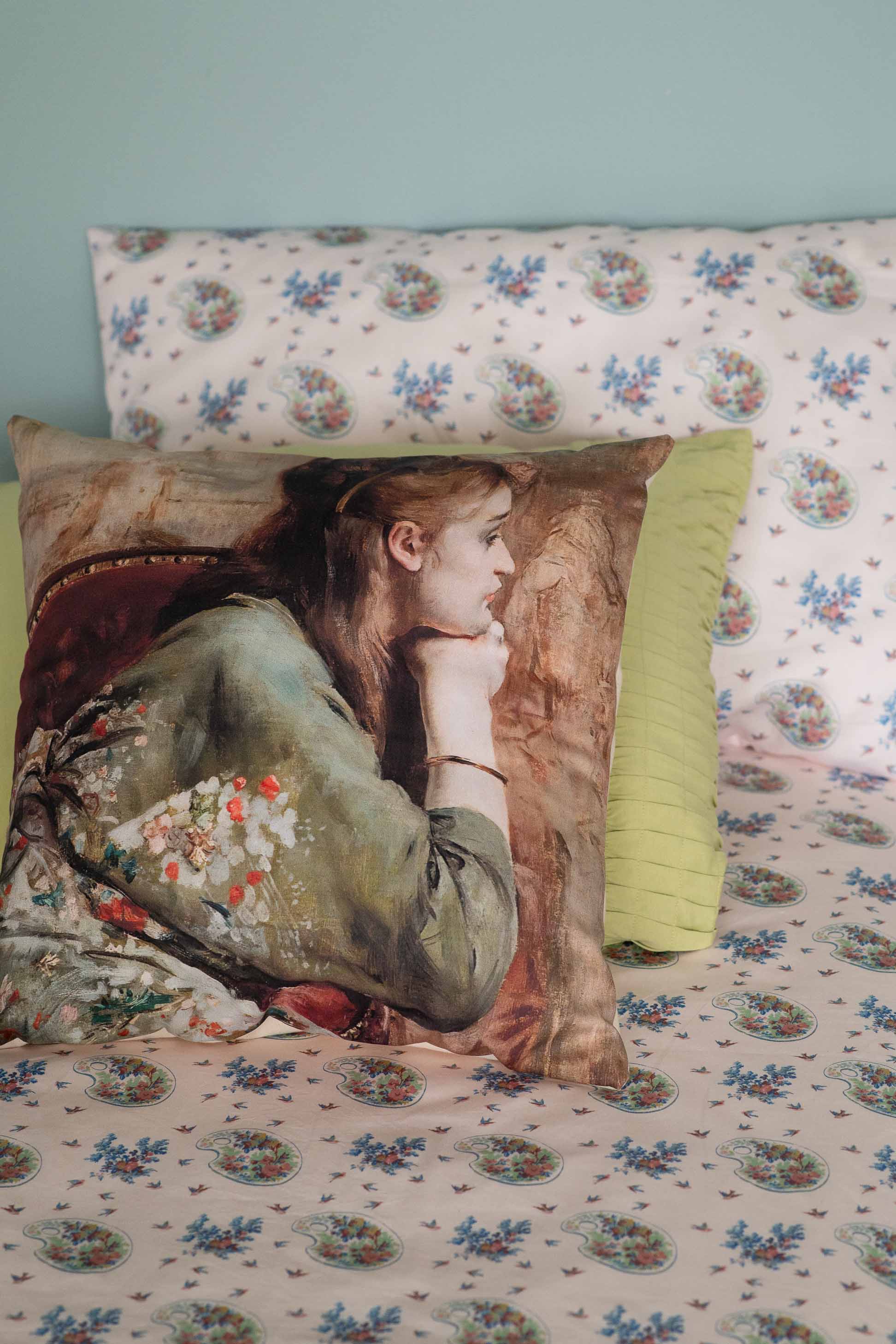 Meditation cushion with art print on bed