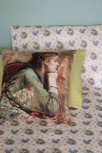 Meditation cushion with art print on bed