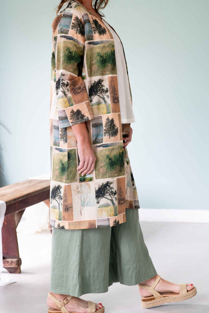 Woman in nature-print kimono and green pants.