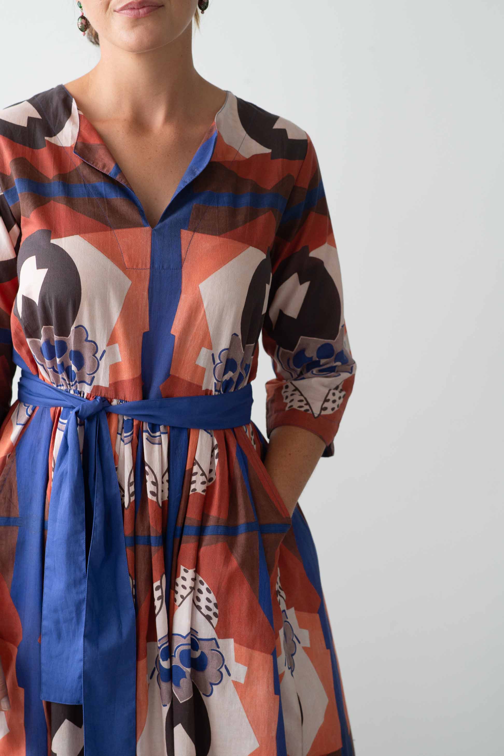 Michaela dress composition with blue sash and floral pattern