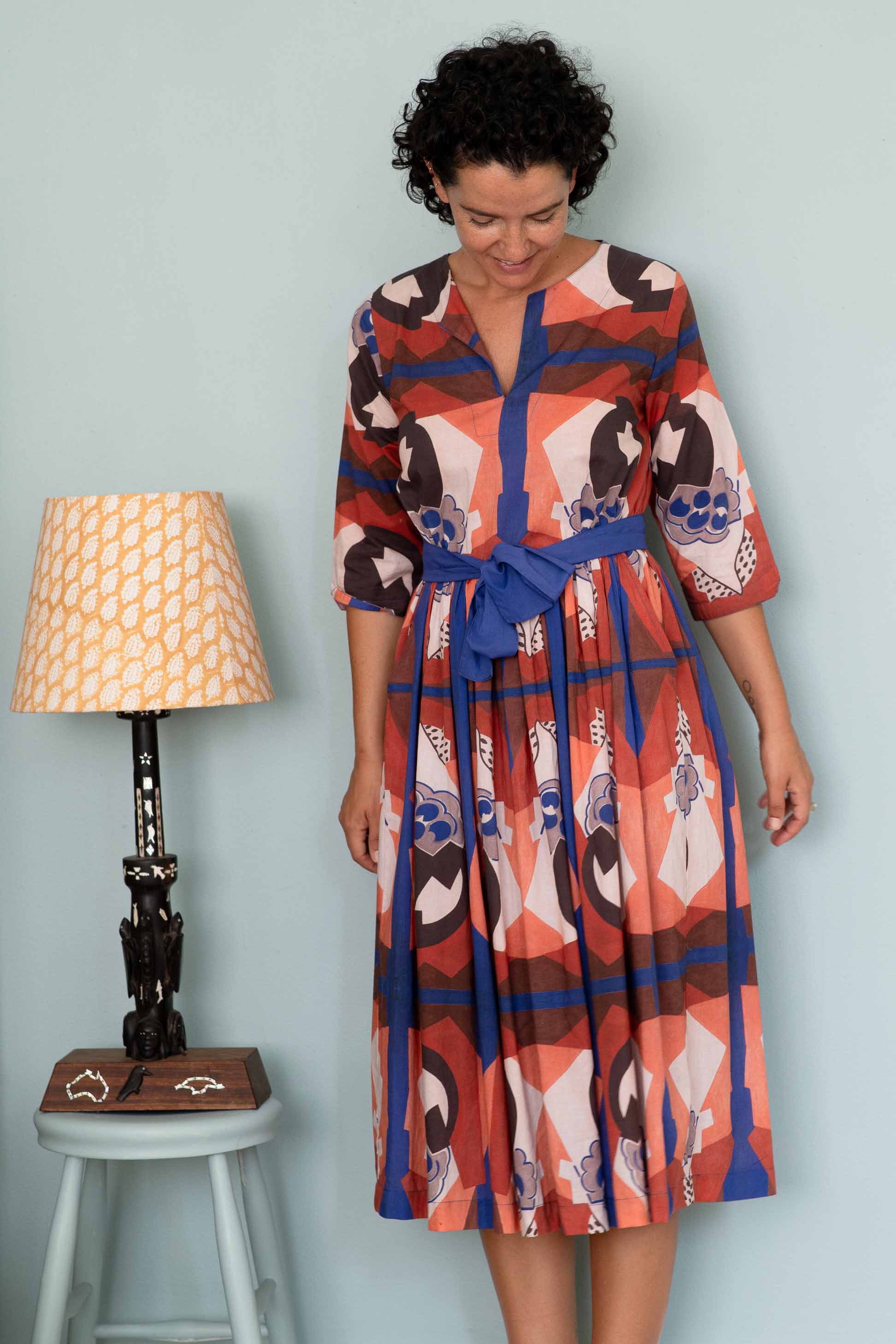 Michaela's dress composition, patterned dress with blue belt.