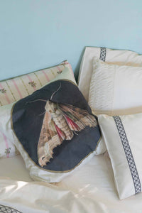 Moth cushion on La Belle Rosette natural sheets