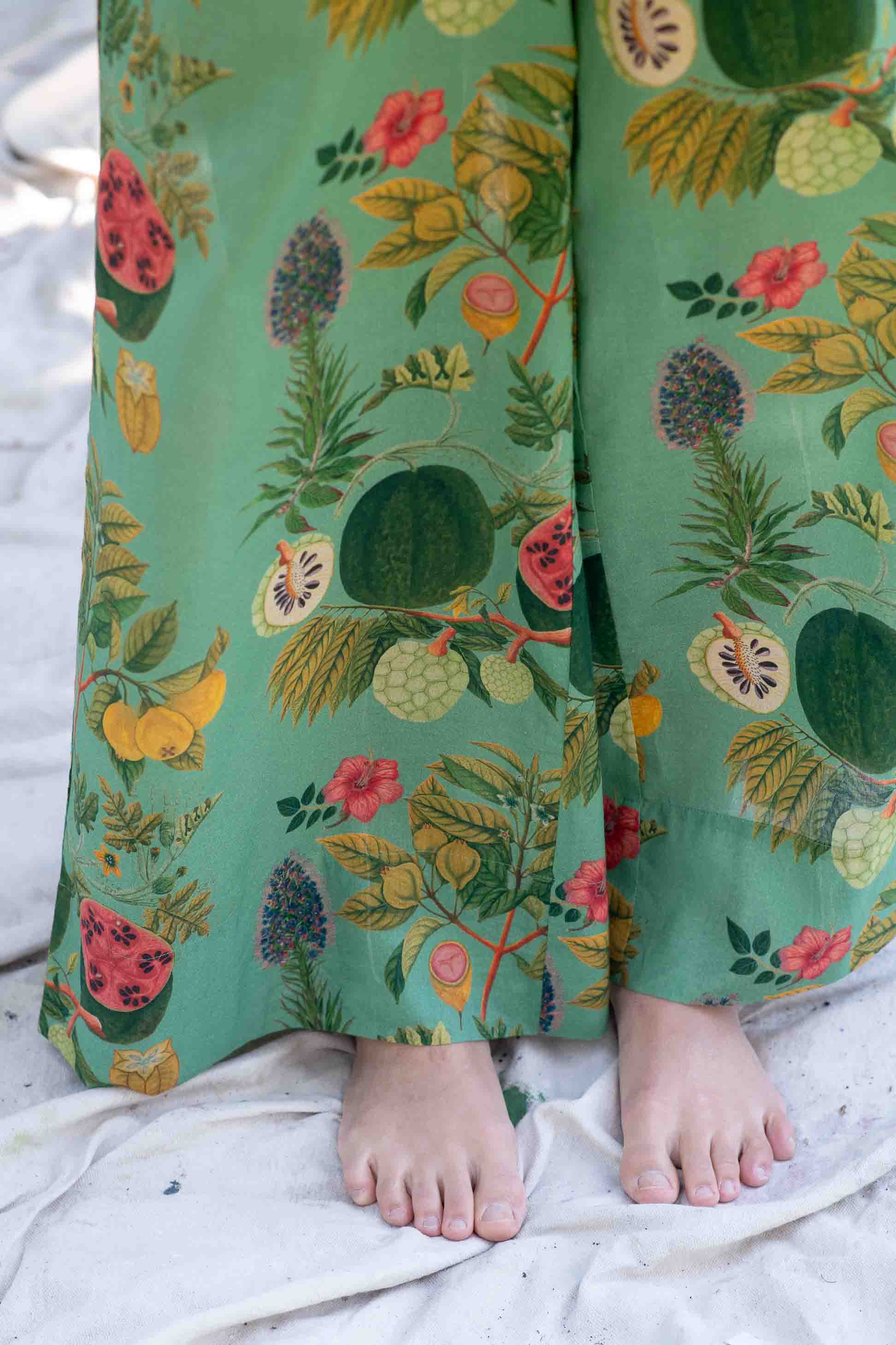 OllieTropics green tropical print pants with bare feet