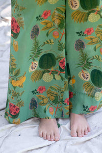 OllieTropics green tropical print pants with bare feet