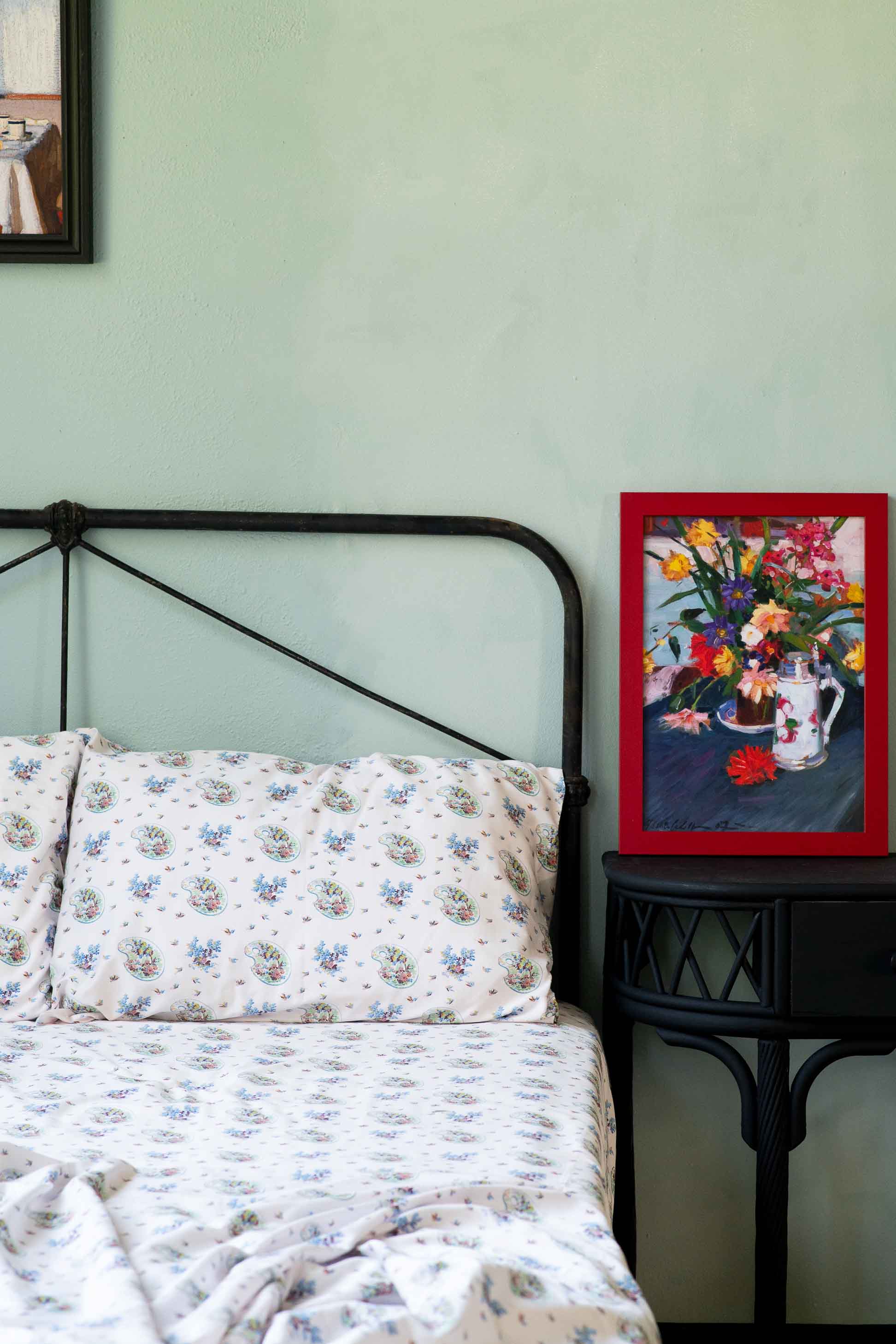 Art print of flowers on bed with floral sheets