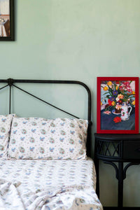 Art print of flowers on bed with floral sheets