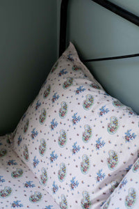 Paisley print pillow on bed