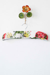 Paradise print padded hanger with floral accent