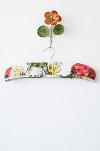 Paradise print padded hanger with floral accent