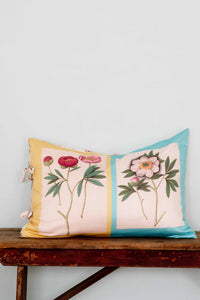Peonies pillow with floral design on wooden table
