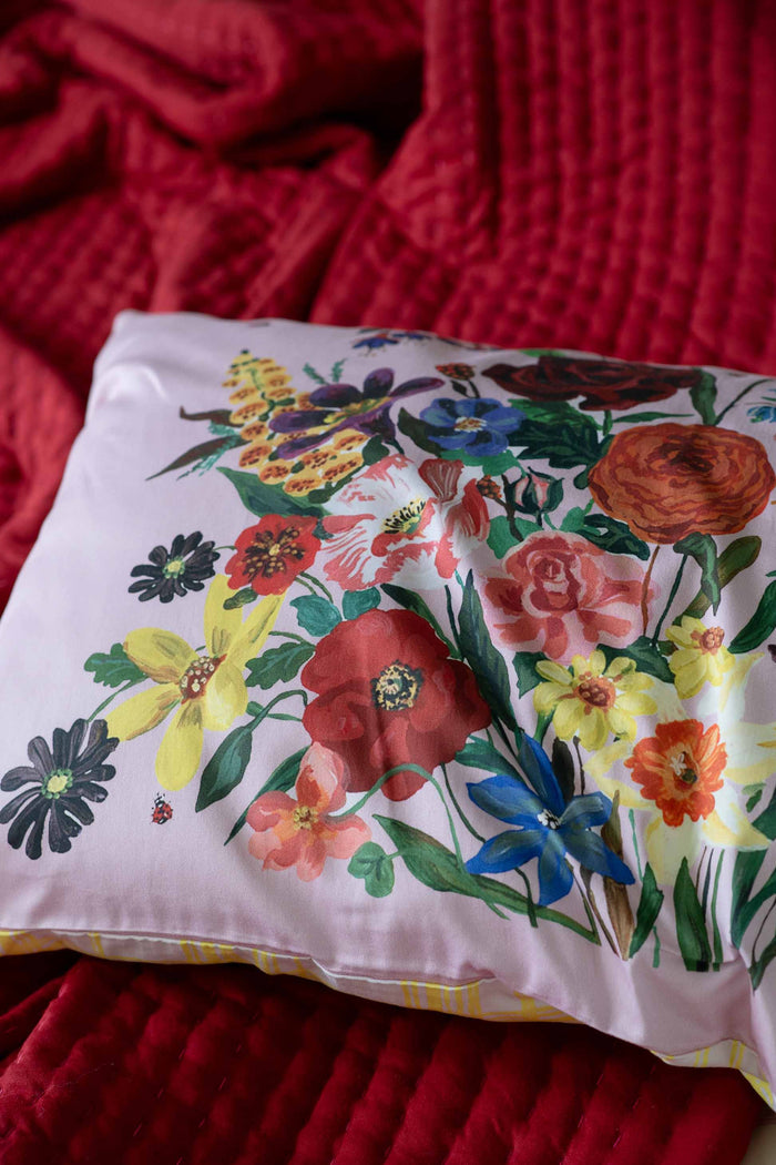 RainbowBunch floral pillow on red blanket