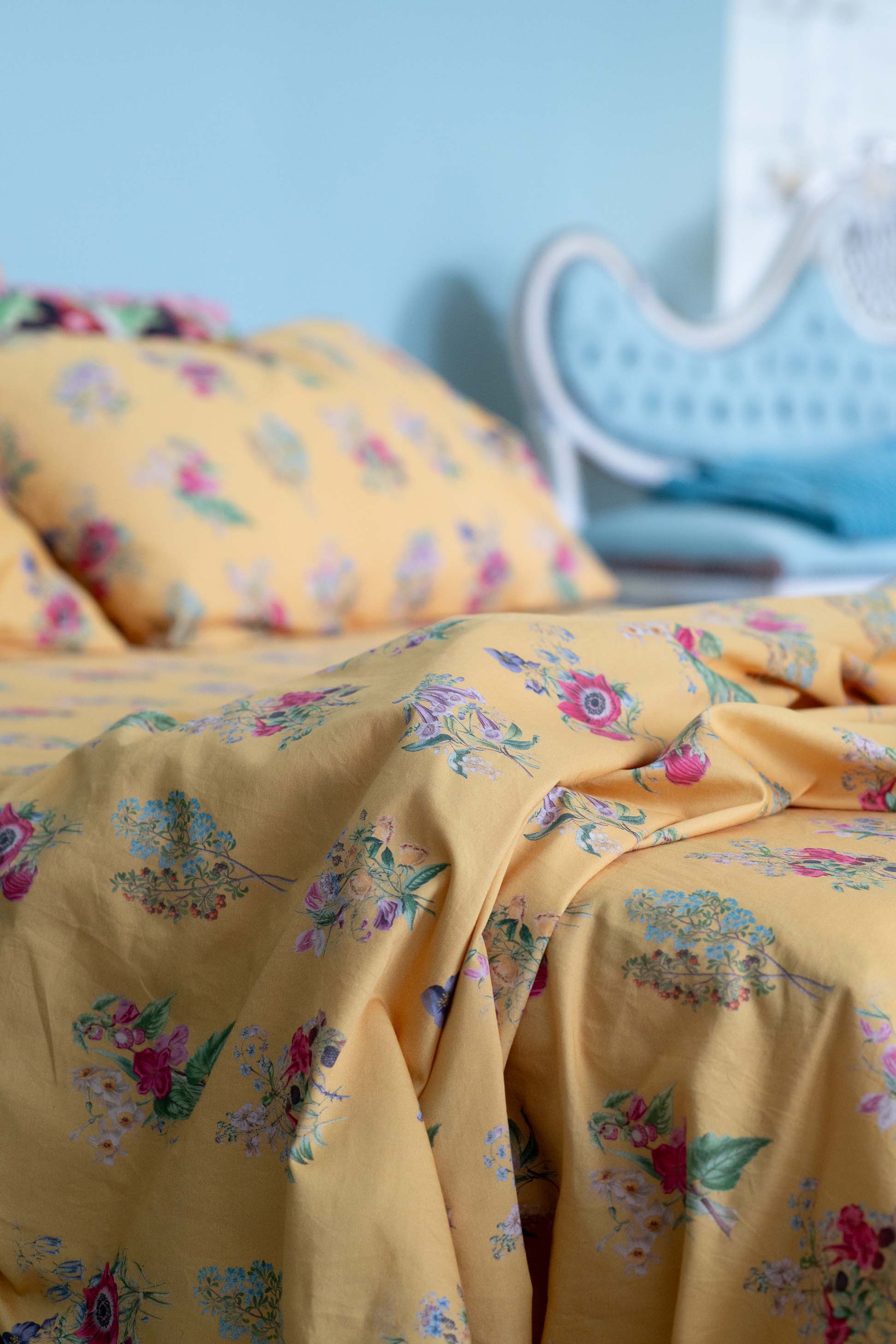Yellow floral bedsheets on display.
