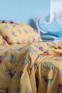 Yellow floral bedsheets on display.
