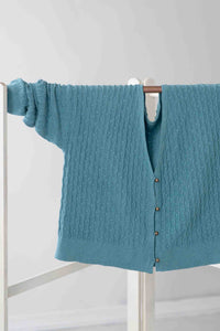 Sunday Cardigan Marine blue cable knit sweater hanging