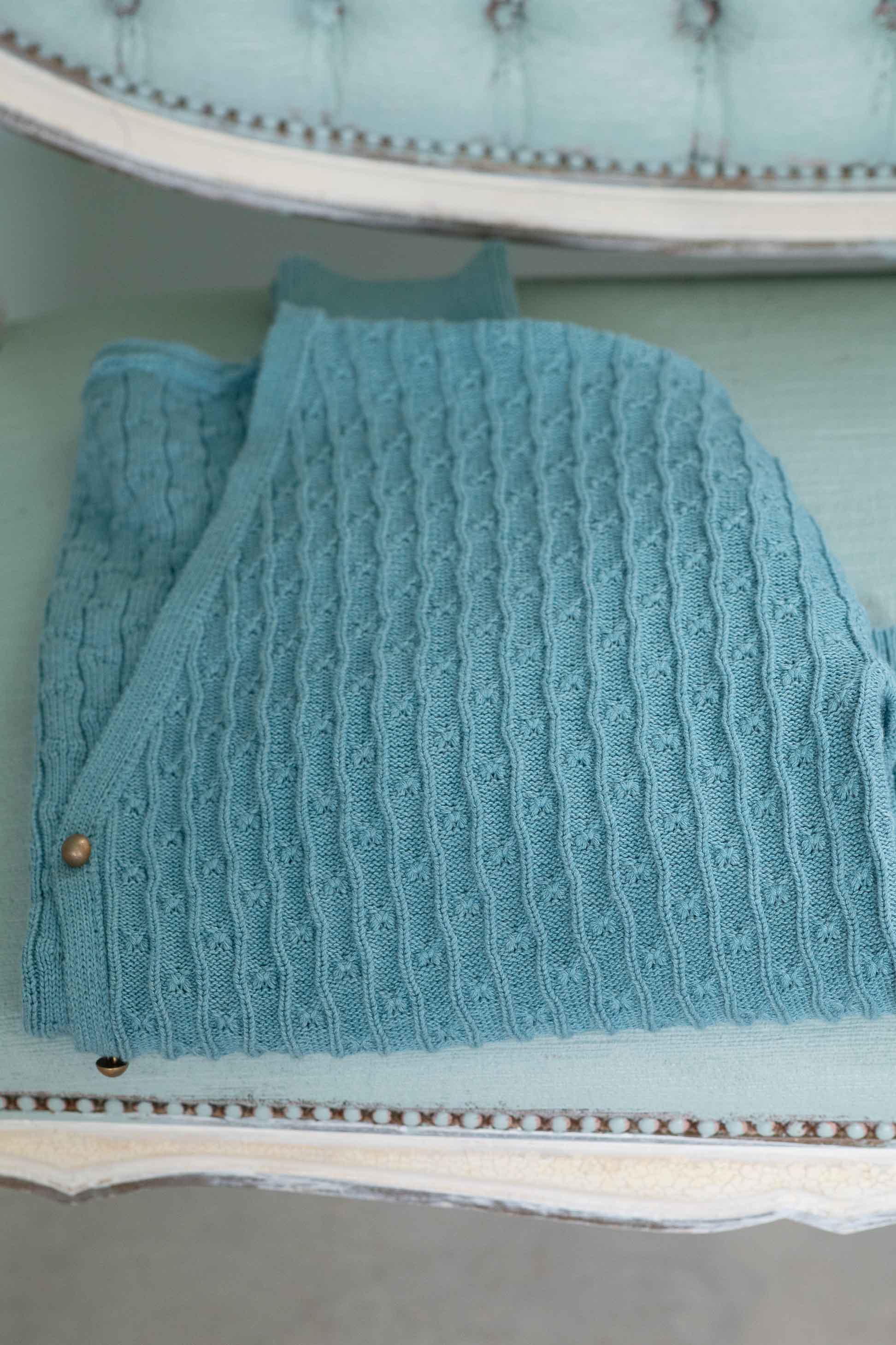 folded blue knit sweater