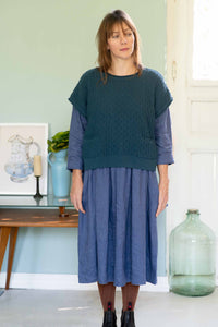 Eliza in teal vest and indigo dress with toffee tights