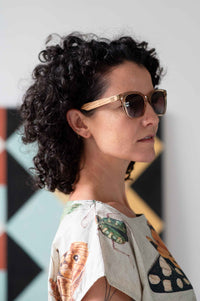 Eleanor wearing sunglasses, insects on shirt.
