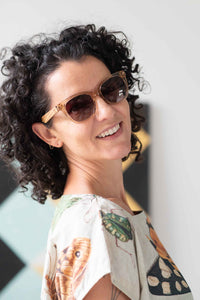 Eleanor wearing sunglasses, insects on shirt