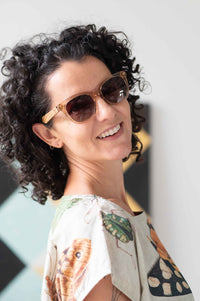 Eleanor wearing sunglasses, insects on shirt