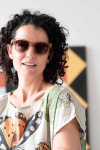 Eleanor wearing sunglasses, insect-themed shirt