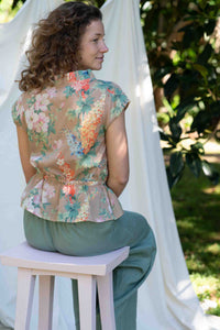 VidaFlora Ollie Mineral Green outfit, woman in floral top and green pants.