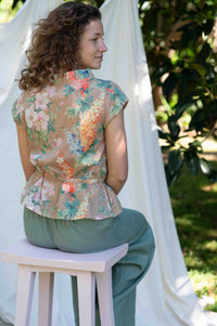 VidaFlora Ollie Mineral Green outfit, woman in floral top and green pants.