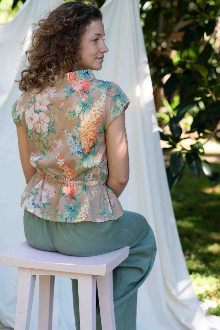 VidaFlora Ollie Mineral Green outfit, woman in floral top and green pants.