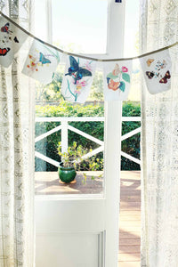 Butterfly garland hanging in window