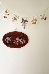 Butterfly garland and dog painting on wall