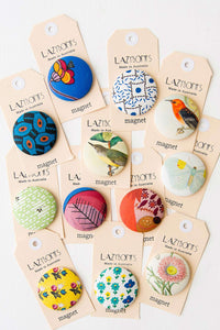 Assorted Lazmonts magnets with colorful designs.