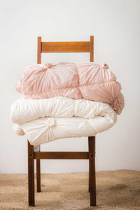 Quilt Rosette, Tuscan Pink and Natural, stacked on chair