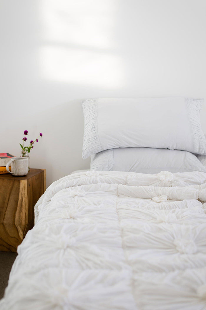 White quilt and pillowcases on bed