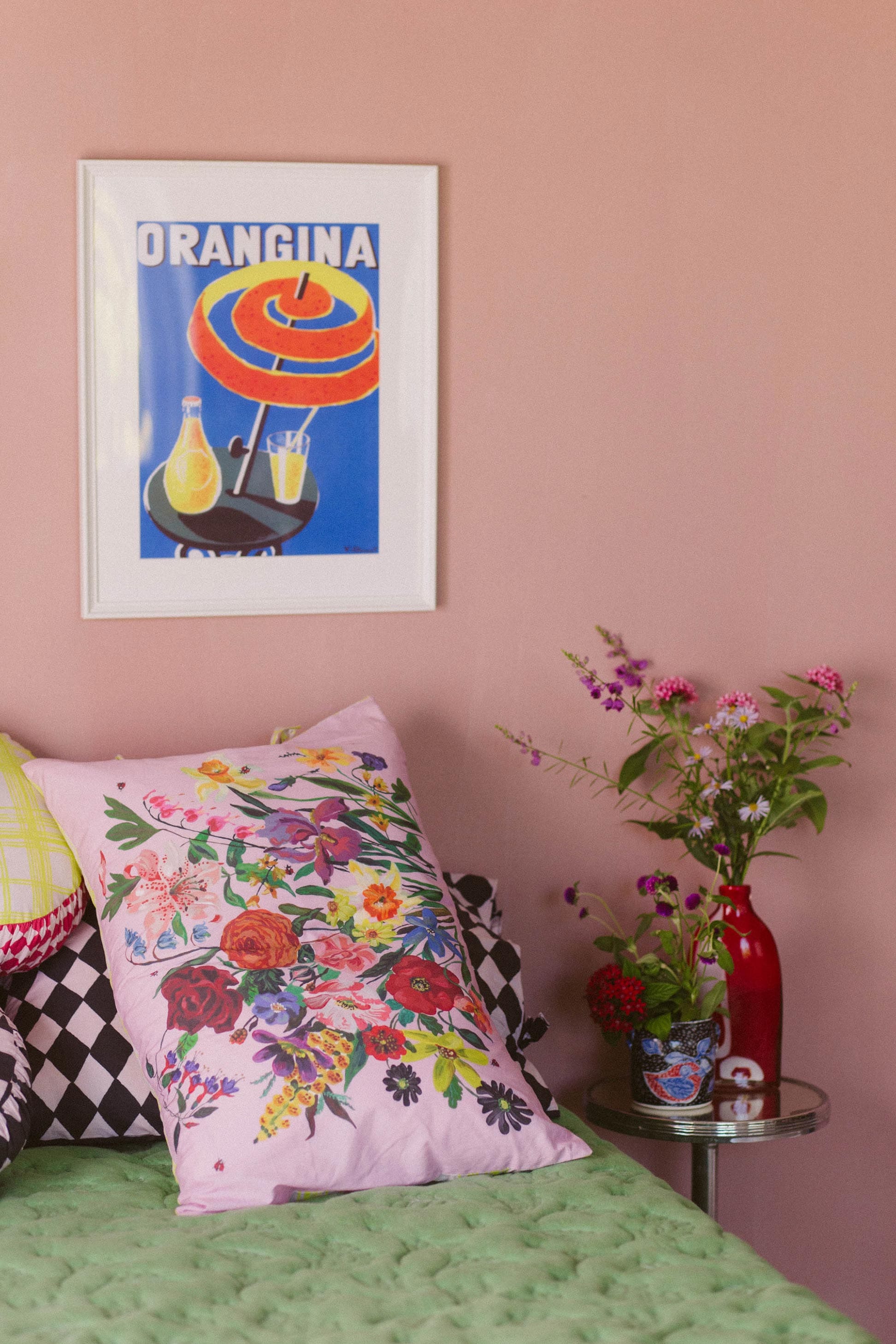 Pink floral pillowcase & Orangina art on pink wall