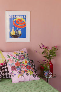 Pink floral pillowcase & Orangina art on pink wall