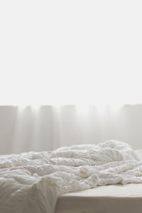 White rosette quilt on bed